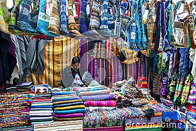 A colourful display of textile products for sale at the Indian Market in Otavalo in Ecuador. Editorial Stock Photo