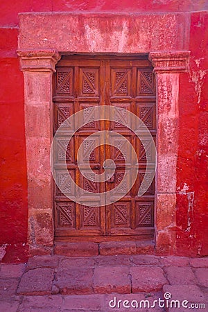 Doorway in a colourful red wall Stock Photo