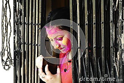 A colourful face of a beautiful woman at the time of Holi - festival of colours Editorial Stock Photo