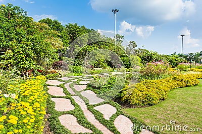 Colourful Flowerbeds and Winding Grass Pathway Stock Photo