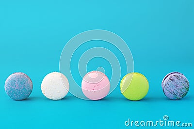 Colourful french macarons on blue pastel background. Sweet concept. Stock Photo