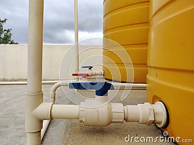 Colourful gate walls to a pipe to control water flow from water tank Stock Photo