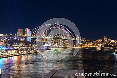 Colourful Light show at night on Sydney Harbour NSW Australia. The bridge illuminated with lasers and neon coloured lights Editorial Stock Photo