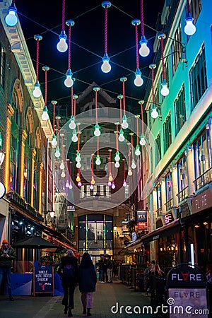 Colourful lights suspended above shoppers as part of the Carnaby Street Christmas decorations Editorial Stock Photo