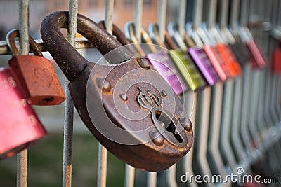 Colourful love padlocks shut to railing on Eiserner Steg bridge in Regensburg, Germany Stock Photo