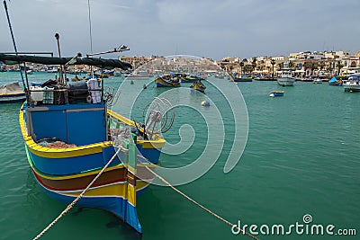 Colourful painted fishing boats in the harbour of Marsaxlokk, Ma Stock Photo