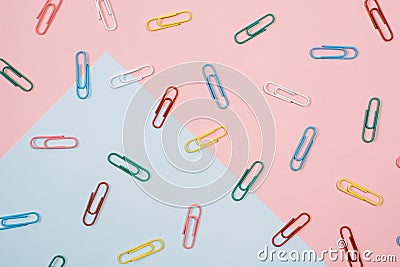 Colourful paper clips on colourful pastel colour background Stock Photo