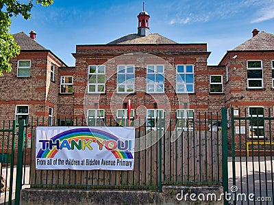 A colourful rainbow banner on railings at the closed Bidston Avenue Primary School in Birkenhead on Wirral in the UK Editorial Stock Photo