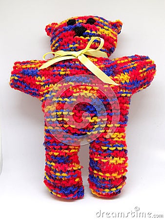 Colourful rainbow knitted teddy bear with ribbon scarf Stock Photo