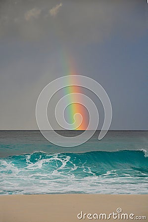Colourful rainbow over the sea in a tropical beach Stock Photo