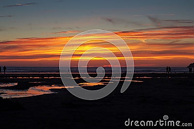 Colourful sunset over the beach at Polzeath Stock Photo