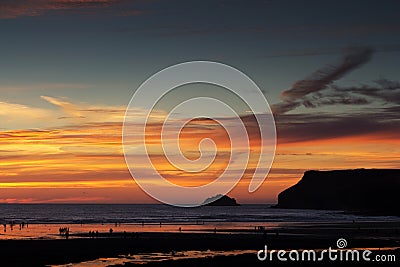Colourful sunset over the beach at Polzeath Stock Photo