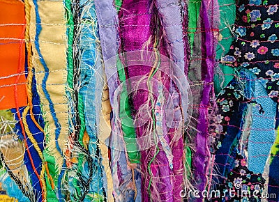 Colourful textured fabric strips sewn together. Textile art background. Stock Photo