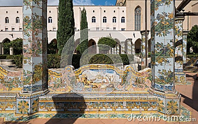 Colourful tiled pillars in the cloister garden at the Santa Chiara Monastery in Via Santa Chiara, Naples Italy. Editorial Stock Photo