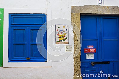 A colourful tiled wall plaque showing a juggling clown on the wall of a holiday bungalow in Albuferia, Portugal Editorial Stock Photo