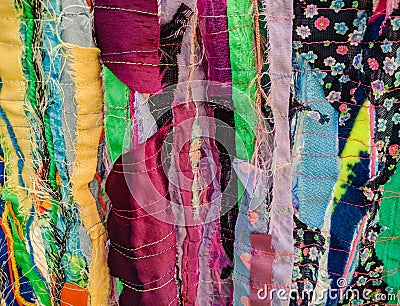 Colourful textured fabric strips sewn together. Textile art background. Stock Photo