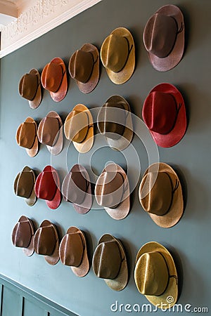 Colourful trilby hat collection, displayed on a wall Stock Photo