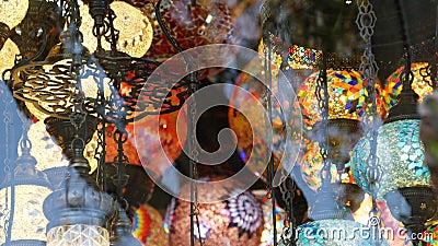 Colourful turkish lamps from glass mosaic glowing. Arabic multi colored authentic retro style lights. Many illuminated moroccan Stock Photo
