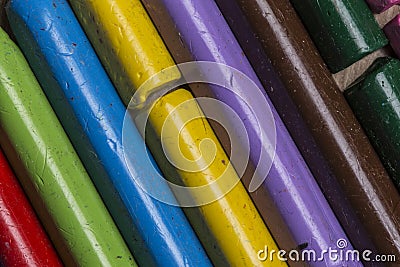 Colourful used crayons close up in a diagonal row Stock Photo