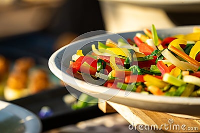 Colourful vegetable slide to lind shape bundle together and arranged lay on whit dish Stock Photo