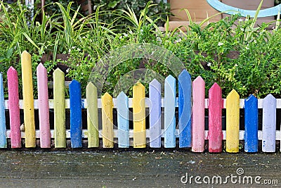 Colourful wood fence in small garden Stock Photo