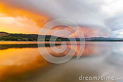 Sunset with heavy clouds at lake in France Stock Photo