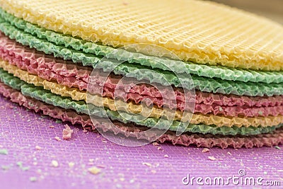 Colourfull waffles on purple desk. Textured abstract background. Close up. Stock Photo