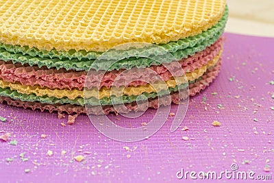 Colourfull waffles on purple desk. Textured abstract background. Close up. Stock Photo