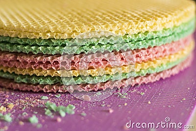 Colourfull waffles on purple desk. Textured abstract background. Close up. Stock Photo