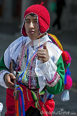 A colourfully dressed boy performs down a Cusco street during the May Day parade in Peru. Editorial Stock Photo