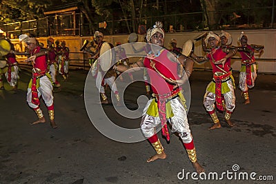 Colourfully dressed dancers perform along the streets of Kandy, Sri Lanka during the Esala Perahara. Editorial Stock Photo