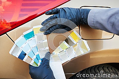 Colourist man selecting color of car with paint matching samples Stock Photo