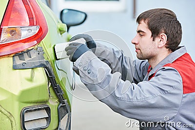 Colourist man selecting color of car with paint matching scanner Stock Photo