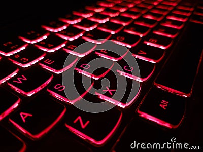 Colse up for RGB Keyboard. A blue light ambient keyboard. Bright multicolor macro black keyboard button background. Close up view Stock Photo