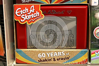 Etch A Sketch is a mechanical drawing toy with controls to make symmetrical patterns. Editorial Stock Photo