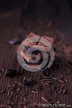 Column of dark or bitter or milk chocolate on a wood background Stock Photo