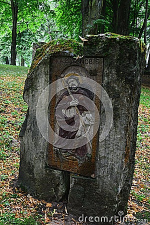 Column with religious icon and sentence `Ora Pro Nobis` on top, placed on Island Of Art in center of Orava River Dam Editorial Stock Photo