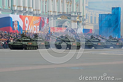 A column of the Russian tanks against the background of festive stands. A dress rehearsal of a parade in honor of the Victory Day Editorial Stock Photo
