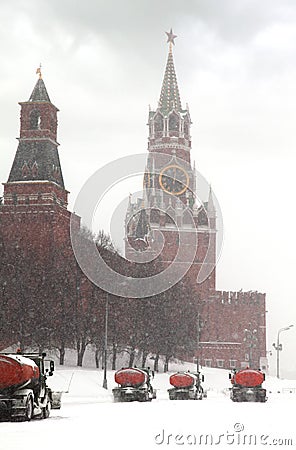 Column of snow-remover trucks on road near Kremlin Stock Photo