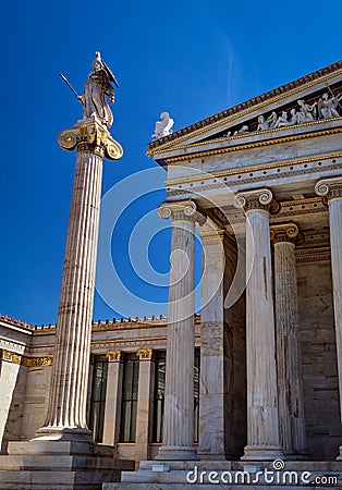 Column with statue of Athena, ancient Greek goddess, city patron, by main entrance to Academy of Athens, Greece, on Stock Photo