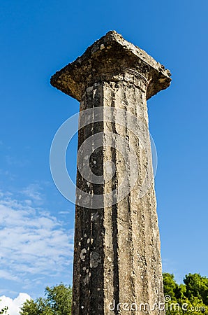 Column of white marble against the blue sky and clouds. Olympia, Peloponnes, Greece Stock Photo