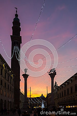 Columns in Piazza dei Signori and the Palladian Basilica in the Christmas period with the cascading lights from Torre Bissara at Stock Photo