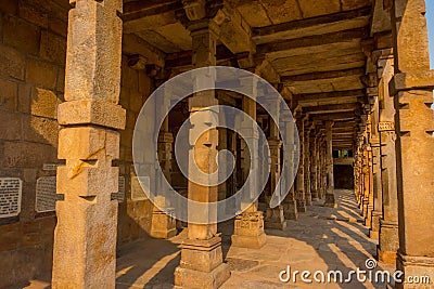 Columns with stone carving in courtyard of Quwwat-Ul-Islam mosque, Qutub Minar complex, Delhi, India Editorial Stock Photo