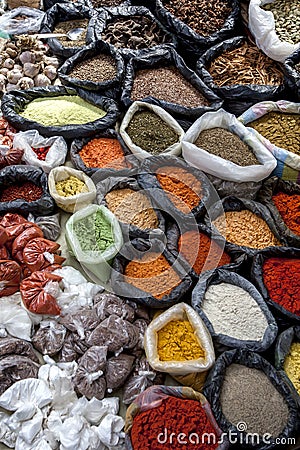 A colurful selection of spices, herbs and nuts for sale at a market stall in the Indian market in Otavalo in Ecuador. Stock Photo