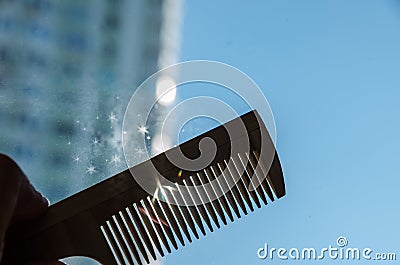 Comb in the hand against the sky Stock Photo