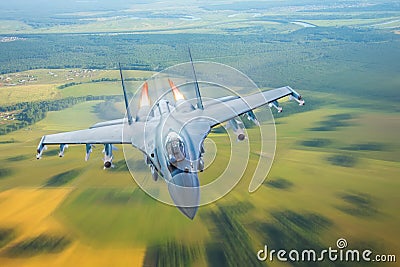 Combat fighter jet on a military mission with weapons - rockets, bombs, weapons on wings, at high speed with fire afterburner engi Stock Photo