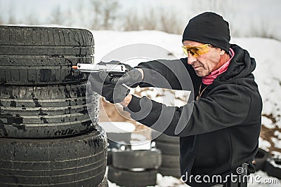 Combat gun tactical shooting behind and around cover or barricade Stock Photo