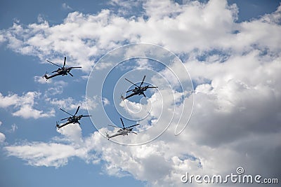 Combat helicopters fly against the background of the cloudy sky. Cloudy sky. Editorial Stock Photo