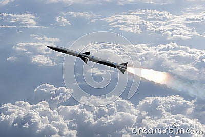 A combat rocket is flying above the clouds, smoke and fire from the rocket. Concept: missile attack, air attack, war between Russi Stock Photo