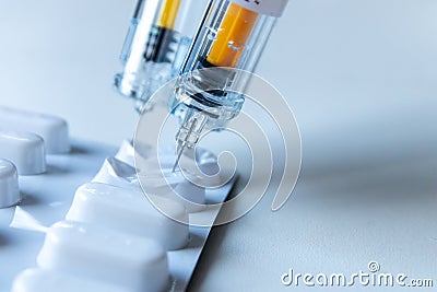 Combination of pills and injections as new medical vaccines ready for injection with syringe and vaccine inject the cure for immun Stock Photo